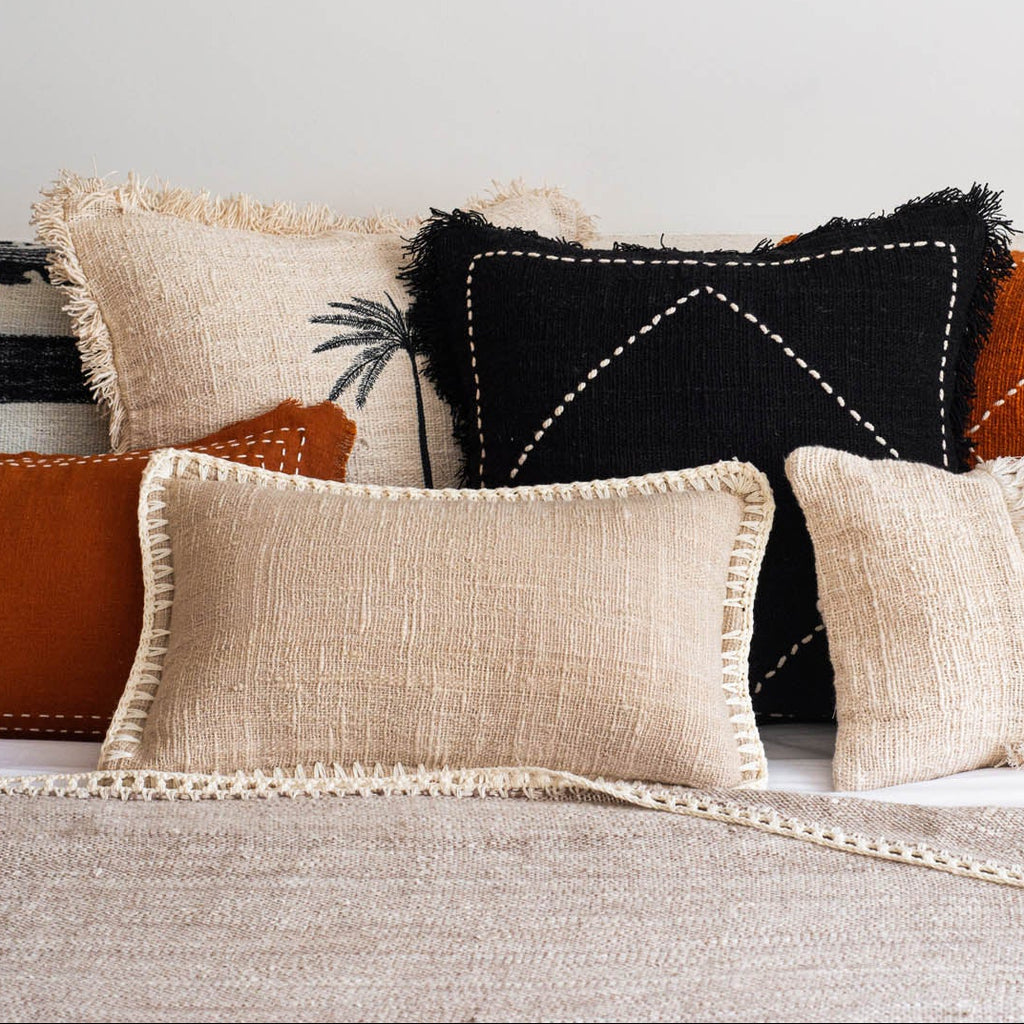 Decorative pillows on a sofa with a neutral color palette