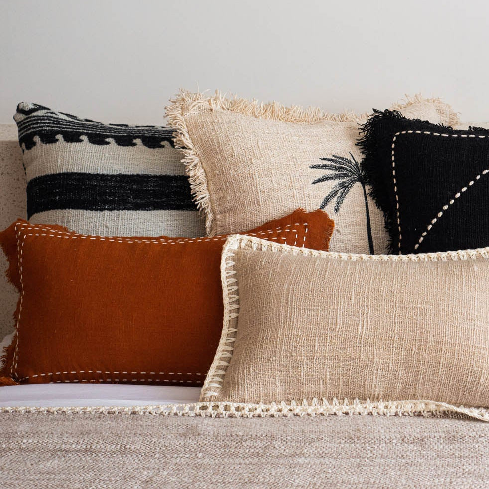 Decorative pillows on a sofa with a neutral color palette