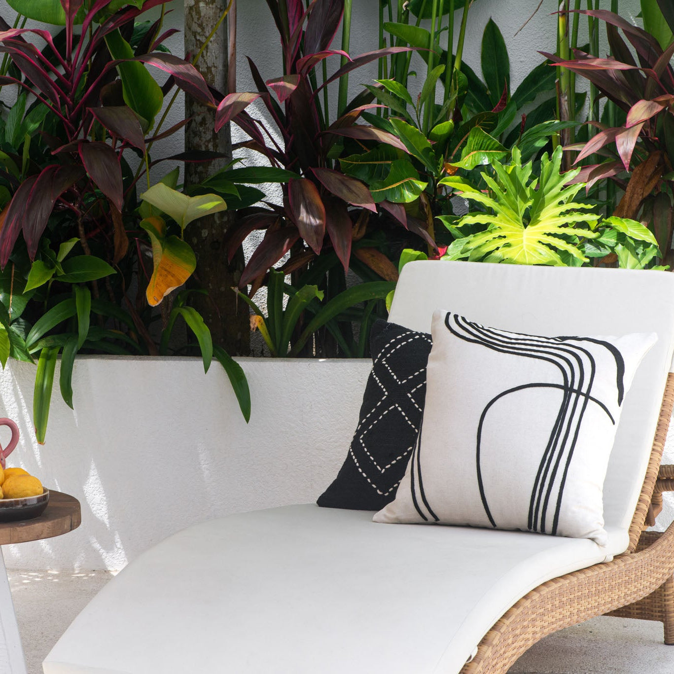 Black and white cushions on  chair 