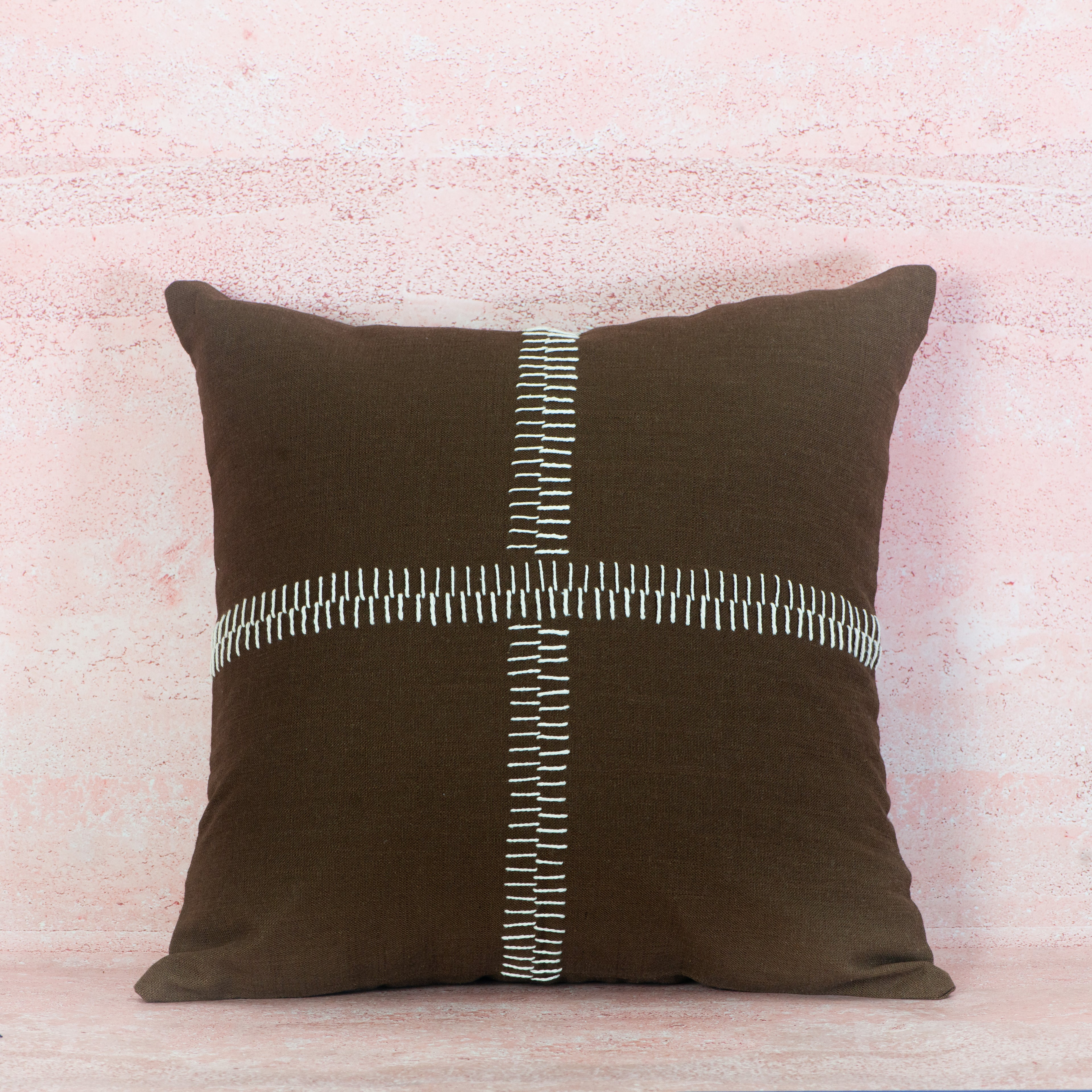 Brown pillow with a white zipper design 