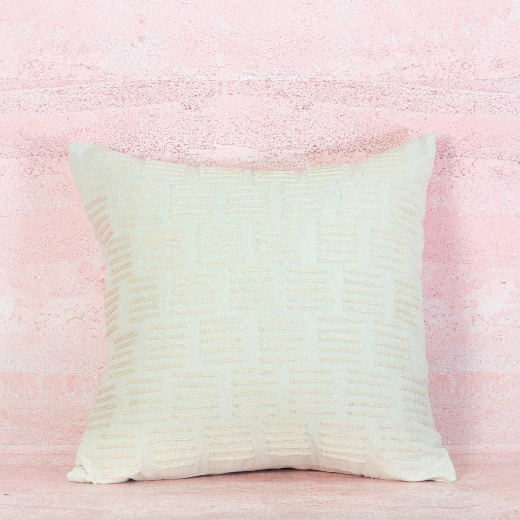White Textured pillow on a pink textured background