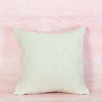 White Textured pillow on a pink textured background