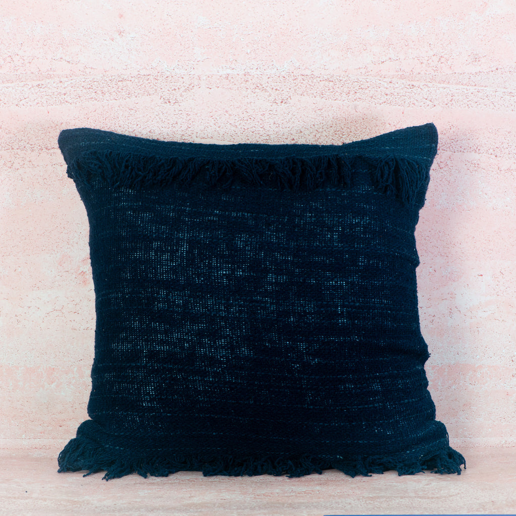 Dark blue textured pillow with horizontal fringe top and bottom 