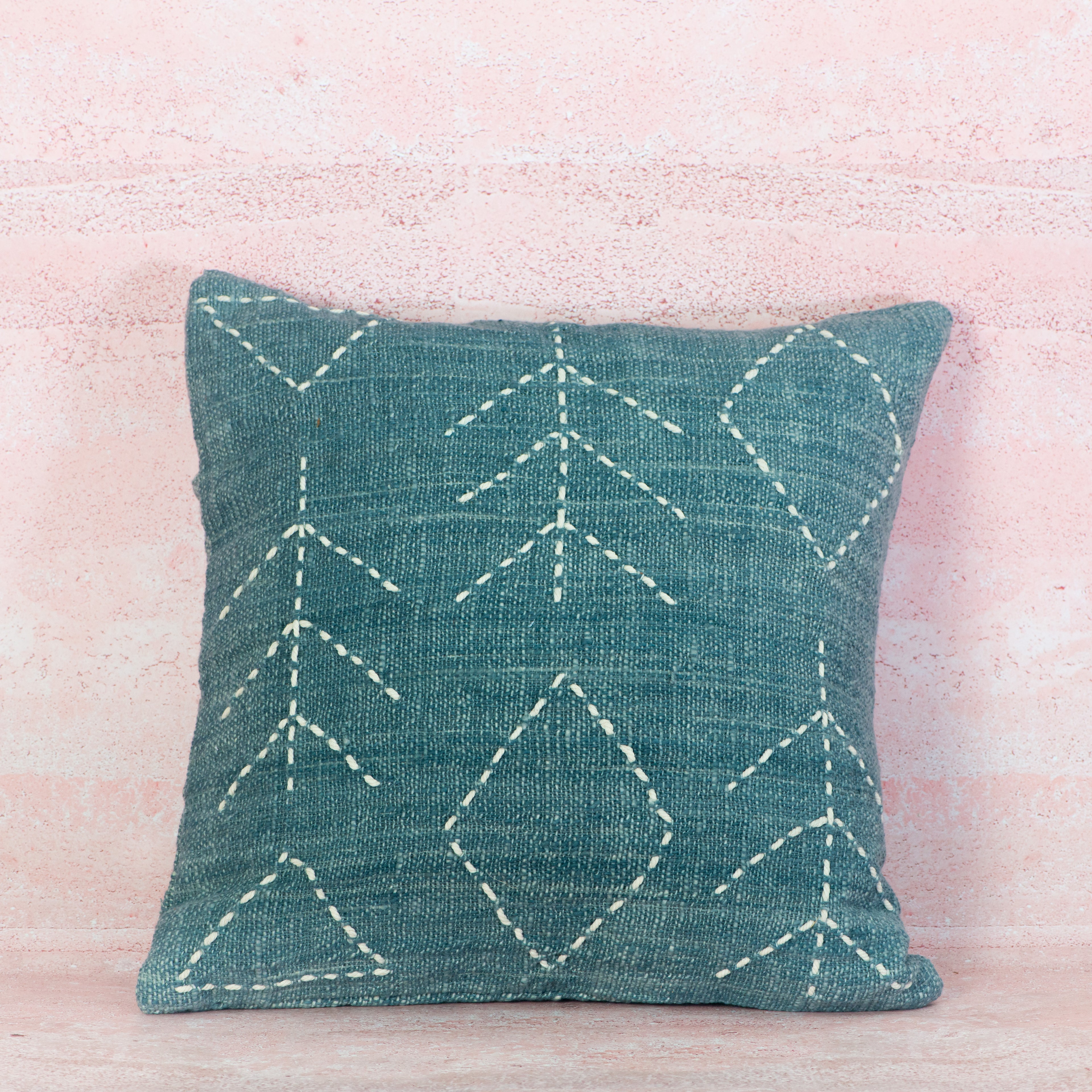 Light blue cushion with white stitching 