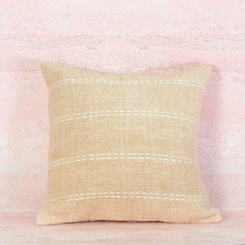 Peach cushion with horizontal white stitching