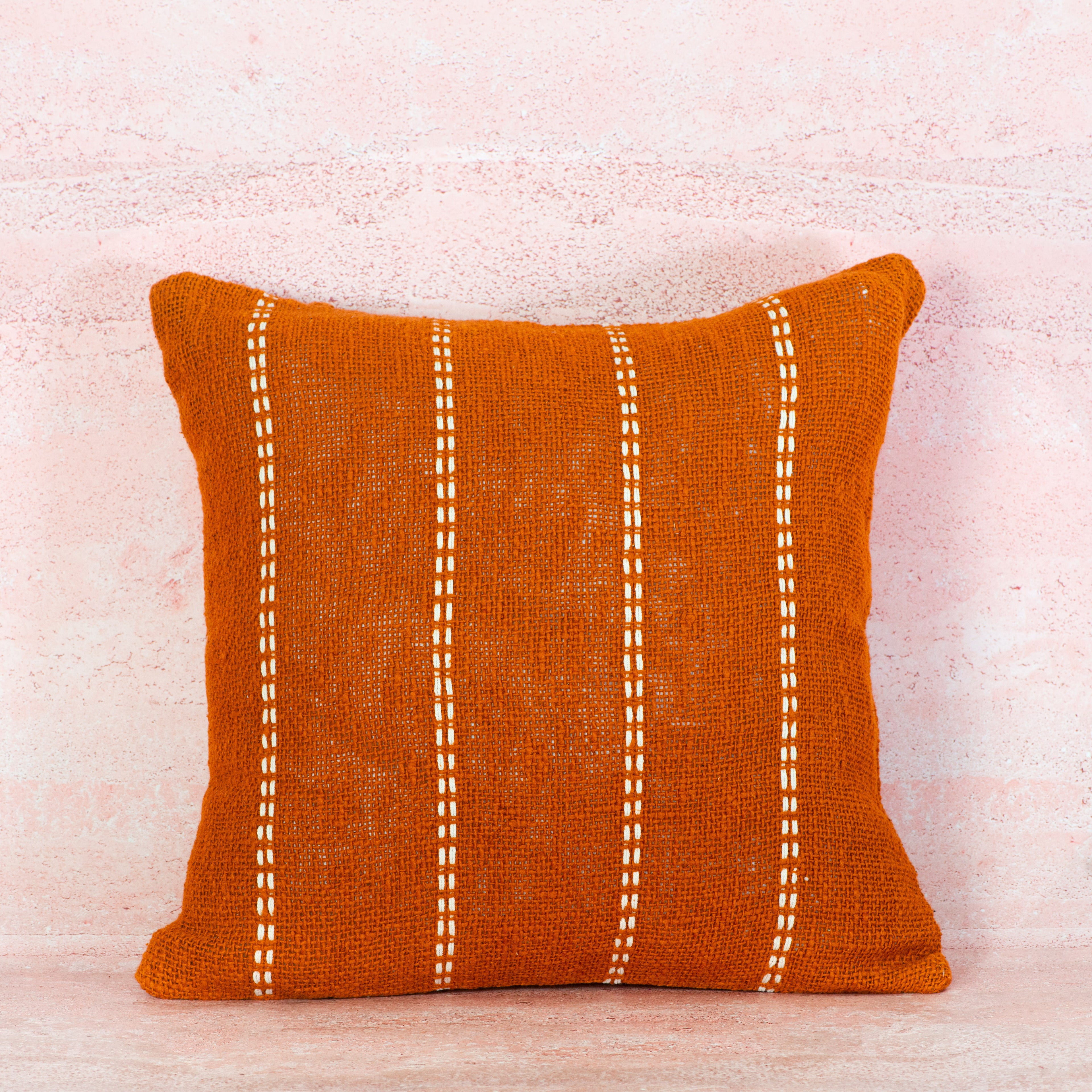 Terracotta pillow with white stitching 